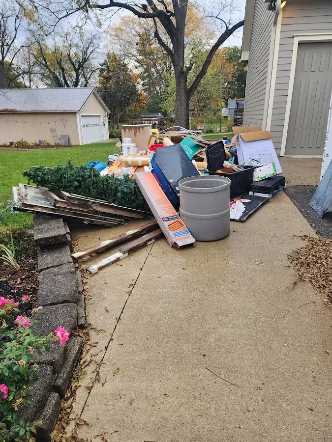 Dumpster being loaded with debris for Residential Dumpster Rental in Ellsworth